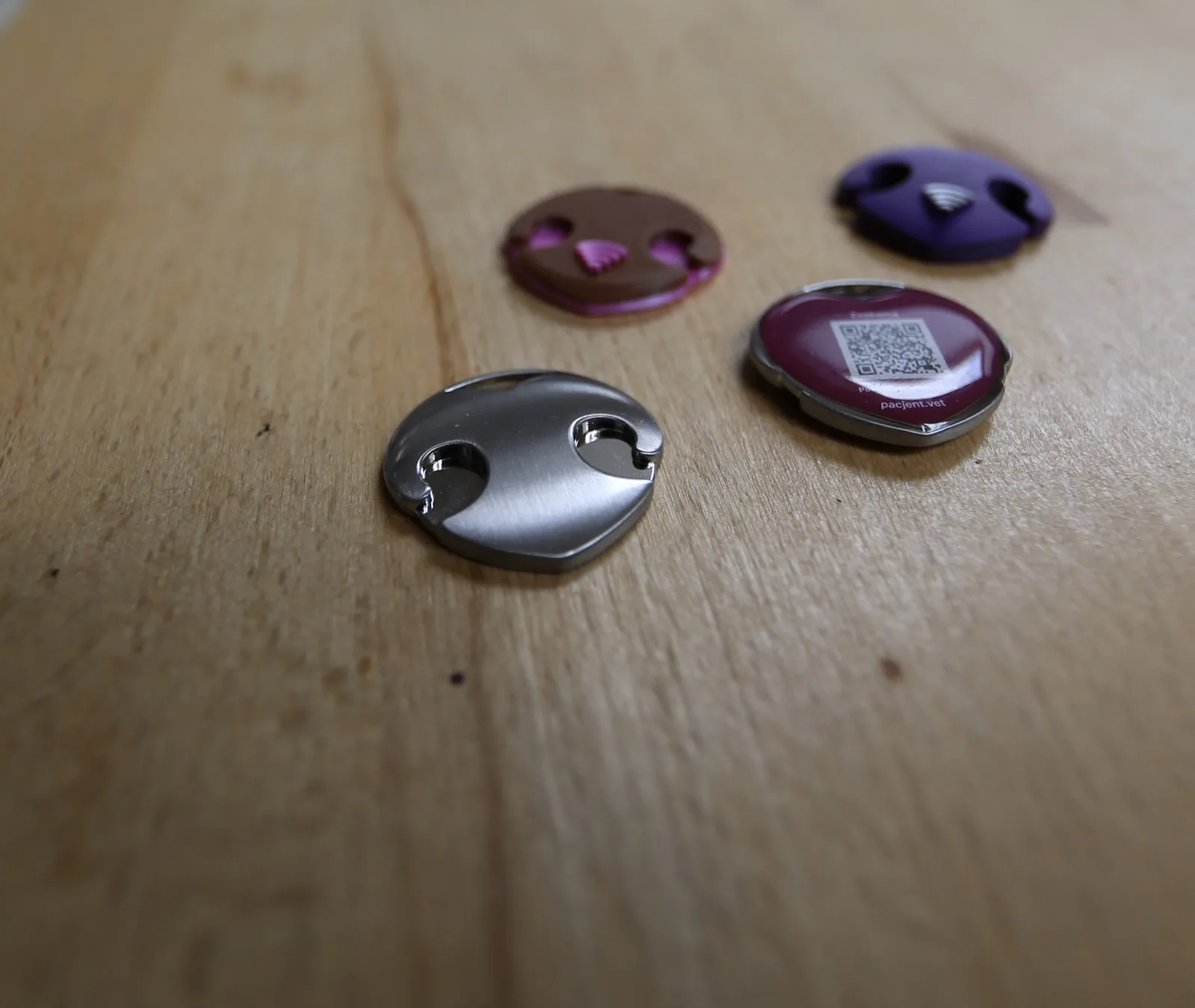 Close-up of the pacjent.vet stainless-steel NFC tag — production photo